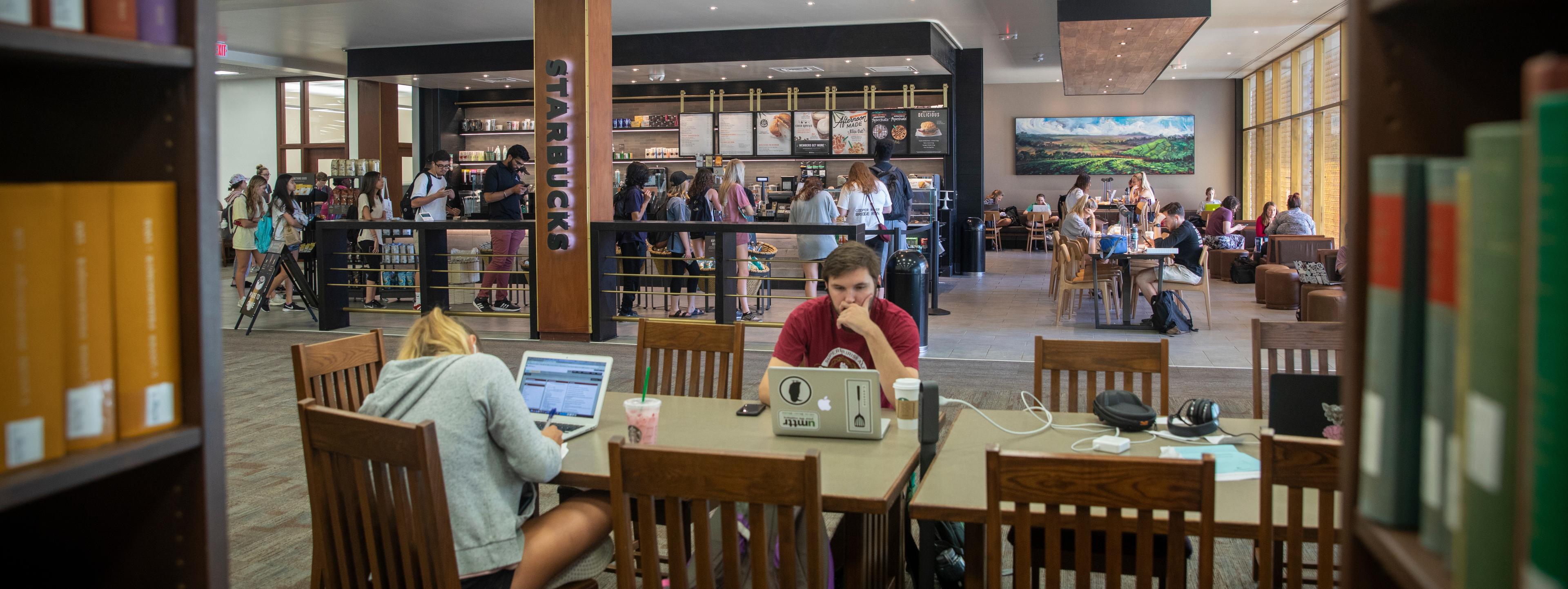 Students studying and lining up at USC Starbucks library.