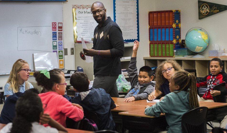 A former South Carolina service member leads a lesson with his elementary school students.